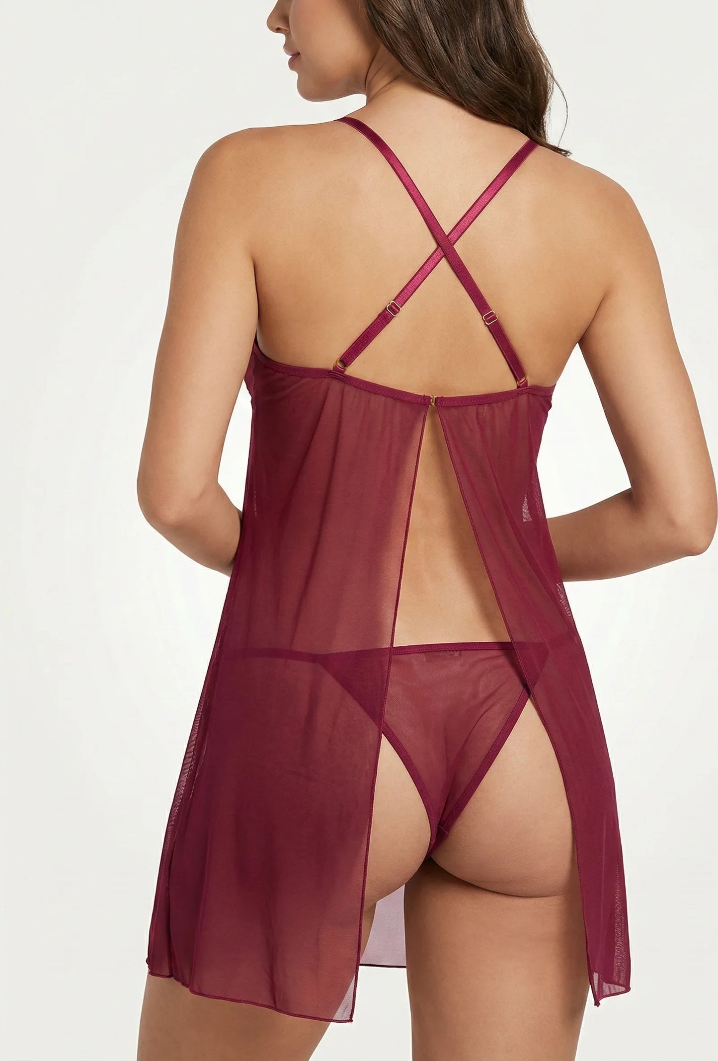 Woman wearing a sheer burgundy nightgown on a white background